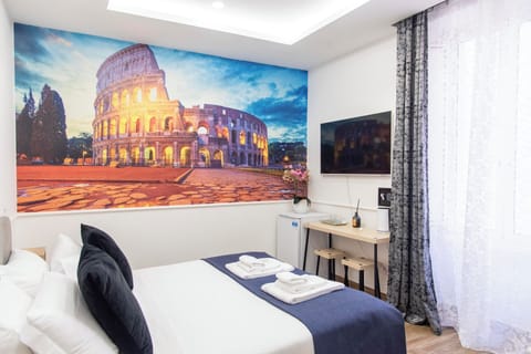 Room Colosseo, queen bed, AC/Heat, non-smoking, private bathroom | Desk, laptop workspace, blackout drapes, iron/ironing board