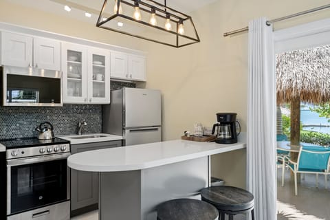 Studio Suite, 1 King Bed, Kitchen (#05 Honeymoon Suite with Tiki Hut) | Private kitchen | Fridge, microwave, highchair