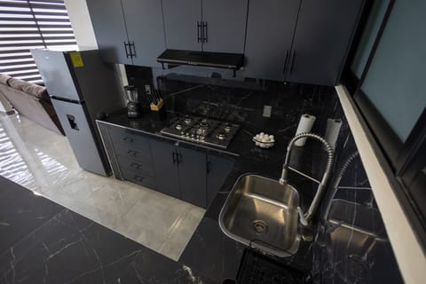 Deluxe Studio, 2 Bedrooms | Private kitchen | Cookware/dishes/utensils, dining tables