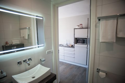 Petite Deluxe Room | Bathroom | Hair dryer, towels, soap, shampoo