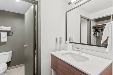 Premium bedding, desk, laptop workspace, blackout drapes