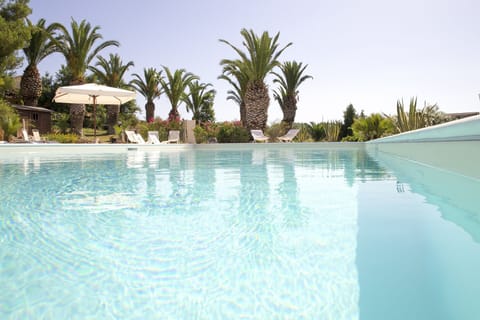 Seasonal outdoor pool, open 10:00 AM to 7:00 PM, pool umbrellas