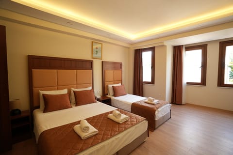 Family Quadruple Room | Minibar, in-room safe, blackout drapes, free WiFi