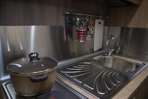 Mini-fridge, stovetop, cookware/dishes/utensils