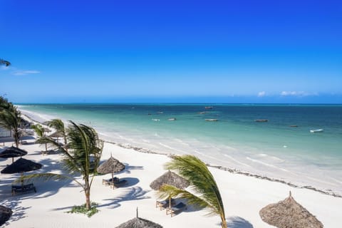 On the beach, white sand, sun loungers, beach umbrellas