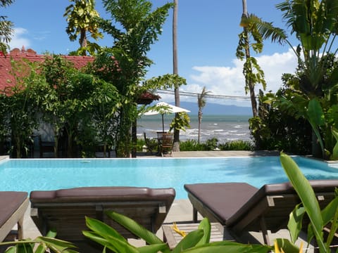 Outdoor pool, an infinity pool, pool umbrellas, sun loungers