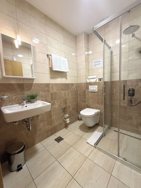 Shower, hair dryer, slippers, towels