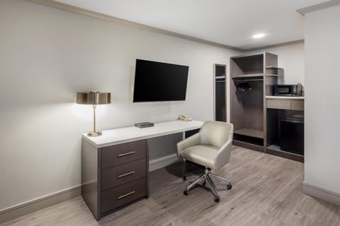 Premium bedding, desk, laptop workspace, blackout drapes