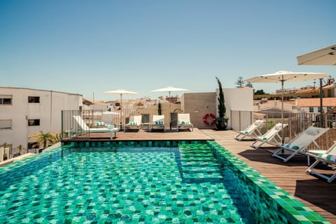 Outdoor pool, open 8:00 AM to 8:00 PM, pool umbrellas, sun loungers