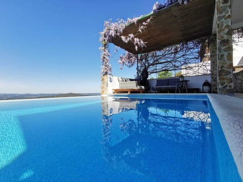 Seasonal outdoor pool, open 10:00 AM to 8:00 PM, pool umbrellas
