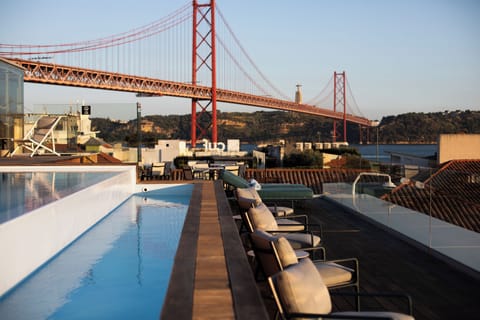 Seasonal outdoor pool, open 11:00 AM to 10:00 PM, pool umbrellas