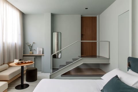 Deluxe Triple Room | Minibar, in-room safe, desk, laptop workspace