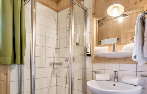 Shower, hair dryer, towels, toilet paper