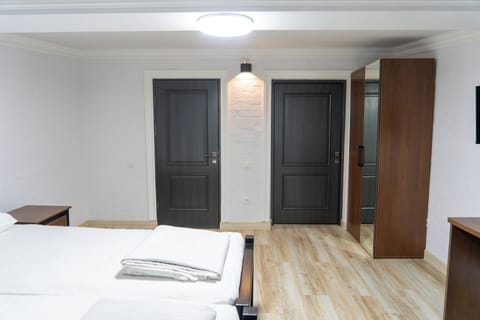 Family Triple Room, City View | In-room safe, desk, laptop workspace, blackout drapes