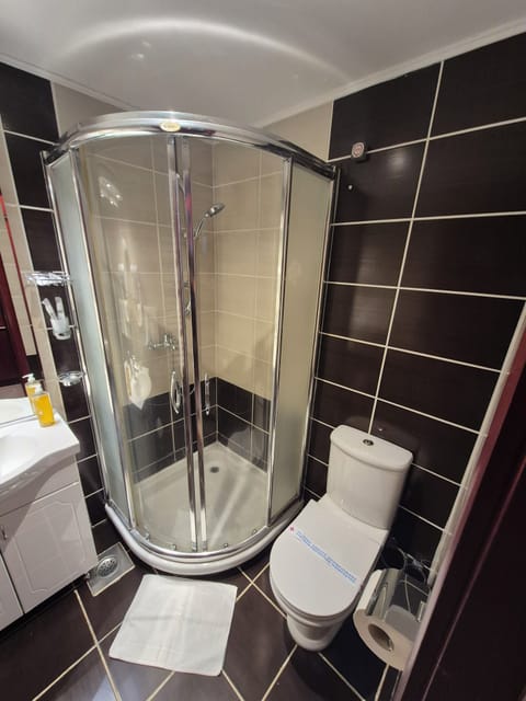 Shower, hair dryer, slippers, towels