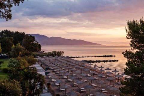 On the beach, white sand, sun loungers, beach umbrellas