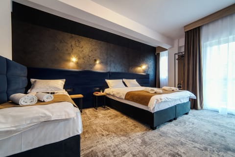 Executive Quadruple Room | In-room safe, blackout drapes, iron/ironing board, free WiFi