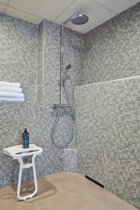 Bathtub, eco-friendly toiletries, hair dryer, towels