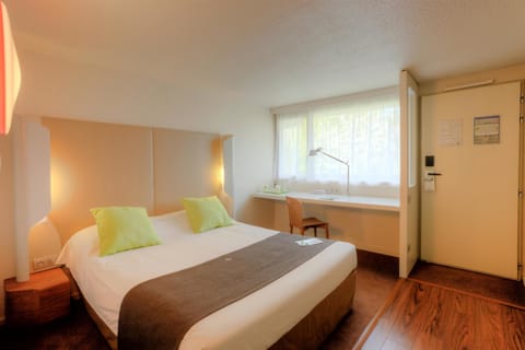 Premium bedding, desk, laptop workspace, blackout drapes