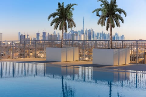 Outdoor pool, open 8:00 AM to 7:00 PM, pool umbrellas