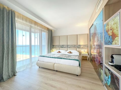 Junior Suite, Side Sea View (Free Beach Access, Safe, Minibar) | Free minibar, in-room safe, desk, bed sheets