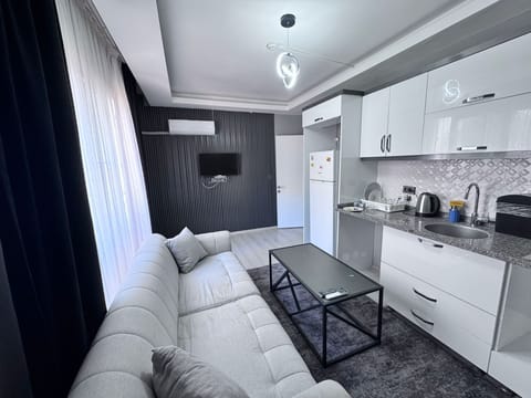 Standard Condo | Living area | 35-inch LED TV with satellite channels
