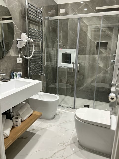 Superior Quadruple Room, Balcony, Courtyard View | Bathroom | Shower, hair dryer, slippers, towels