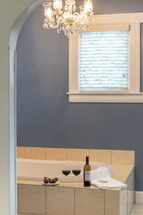 Luxury Suite, 1 King Bed, Jetted Tub | Bathroom | Designer toiletries, hair dryer, towels