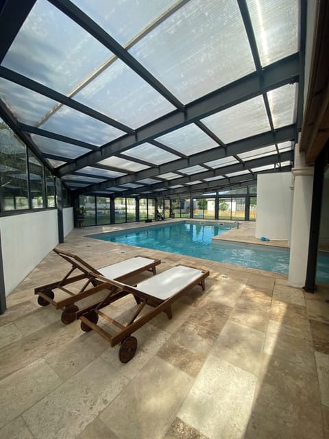 Indoor pool, pool umbrellas, sun loungers