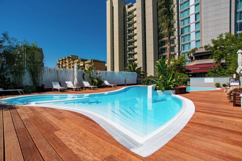 Seasonal outdoor pool, open 10:00 AM to 7:00 PM, pool umbrellas