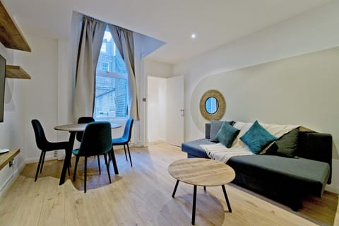 Apartment, City View | Living area | Flat-screen TV