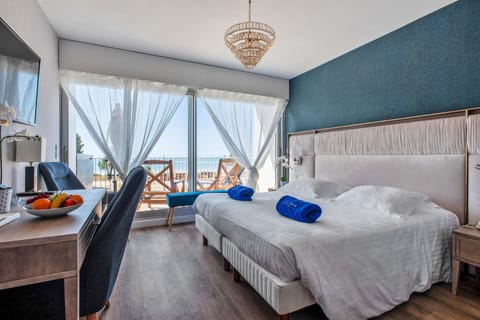 Deluxe Double Room, Terrace, Oceanfront | Minibar, in-room safe, soundproofing, iron/ironing board