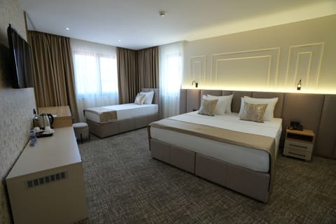 Family Triple Room, City View | Minibar, individually decorated, individually furnished, desk