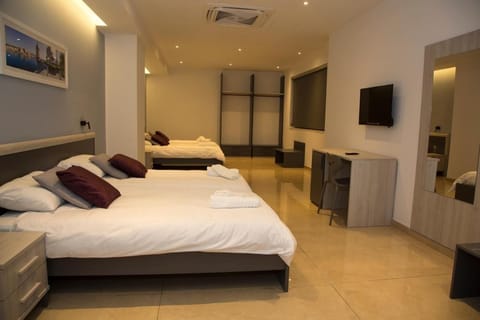 Quadruple Room | In-room safe, desk, laptop workspace, blackout drapes