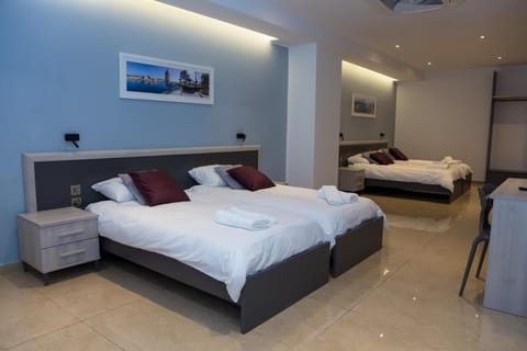 Quadruple Room, 2 Queen Beds, Non Smoking | In-room safe, desk, laptop workspace, blackout drapes