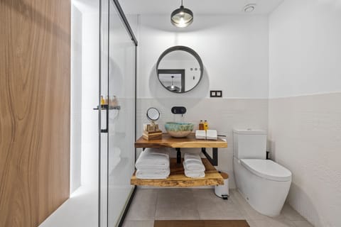 Shower, hair dryer, slippers, towels