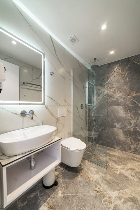 Deluxe Double Room, Balcony, Beach View | Bathroom | Shower, hair dryer, towels, soap