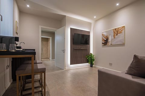 Luxury Suite | Living area | 43-inch LCD TV with satellite channels