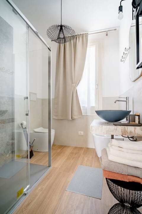 Deluxe Quadruple Room, Patio, Garden View | Bathroom | Shower, hair dryer, towels, soap