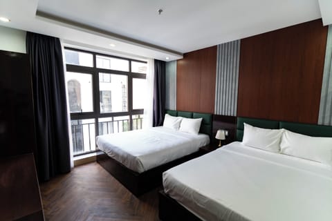Deluxe Triple Room, City View | Desk, laptop workspace, blackout drapes, soundproofing