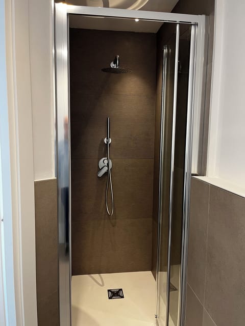 Double Room, City View | Bathroom | Shower, rainfall showerhead, hair dryer, slippers