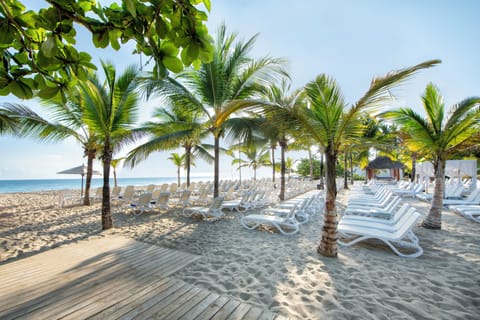 On the beach, white sand, sun loungers, beach towels