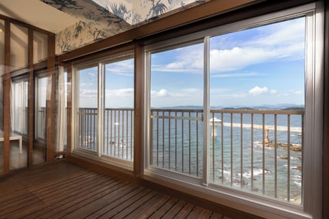 Family Apartment, Ocean View | Living area | 50-inch flat-screen TV with cable channels