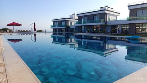 Outdoor pool, open 7:00 AM to 10:00 PM, pool umbrellas, sun loungers