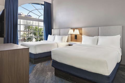 Premium bedding, desk, laptop workspace, blackout drapes
