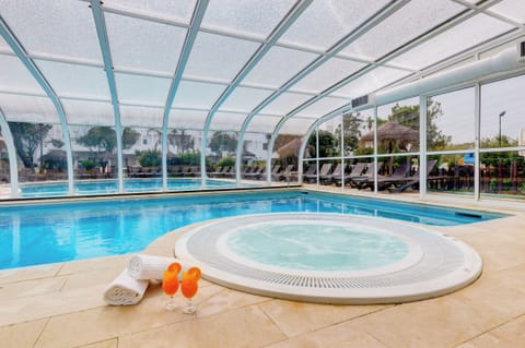 Indoor pool, outdoor pool, open 11:00 AM to 7:00 PM, pool umbrellas