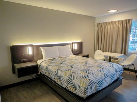 Desk, laptop workspace, blackout drapes, iron/ironing board