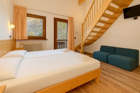 Deluxe Quadruple Room | Premium bedding, down comforters, in-room safe, iron/ironing board