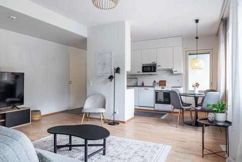 Comfort Apartment, Balcony | Living area | 65-inch Smart TV with cable channels