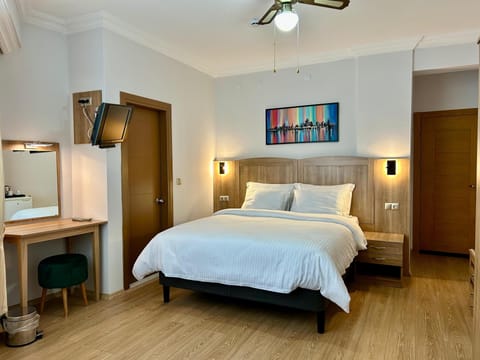 Family Triple Room, City View | Minibar, in-room safe, desk, laptop workspace